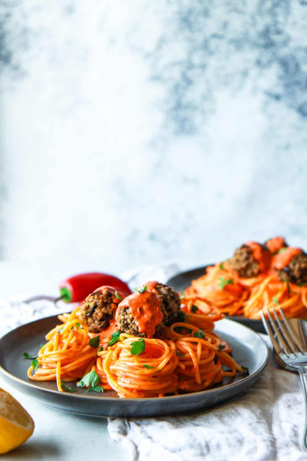 These eggplant meatballs are complemented with a roasted red pepper tahini sauce, served over pasta. Made with eggplants, walnuts, and parsley, these vegan meatballs are gluten-free with an oil-free option.