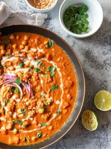 This vegan butternut squash & chickpea panang curry is a sweet, peanut flavored curry, inspired by the classic Thai dish. This vegan Thai peanut curry uses vegan panang curry paste, peanut butter, and coconut milk to create a rich and creamy base. This plant based curry uses chickpea and butternut squash instead of meat. Gluten-free with a n oil-free option.