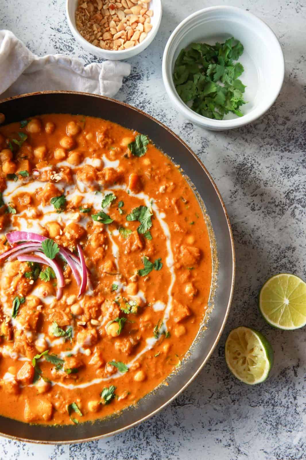 This vegan butternut squash & chickpea panang curry is a sweet, peanut flavored curry, inspired by the classic Thai dish. This vegan Thai peanut curry uses vegan panang curry paste, peanut butter, and coconut milk to create a rich and creamy base. This plant based curry uses chickpea and butternut squash instead of meat. Gluten-free with a n oil-free option.