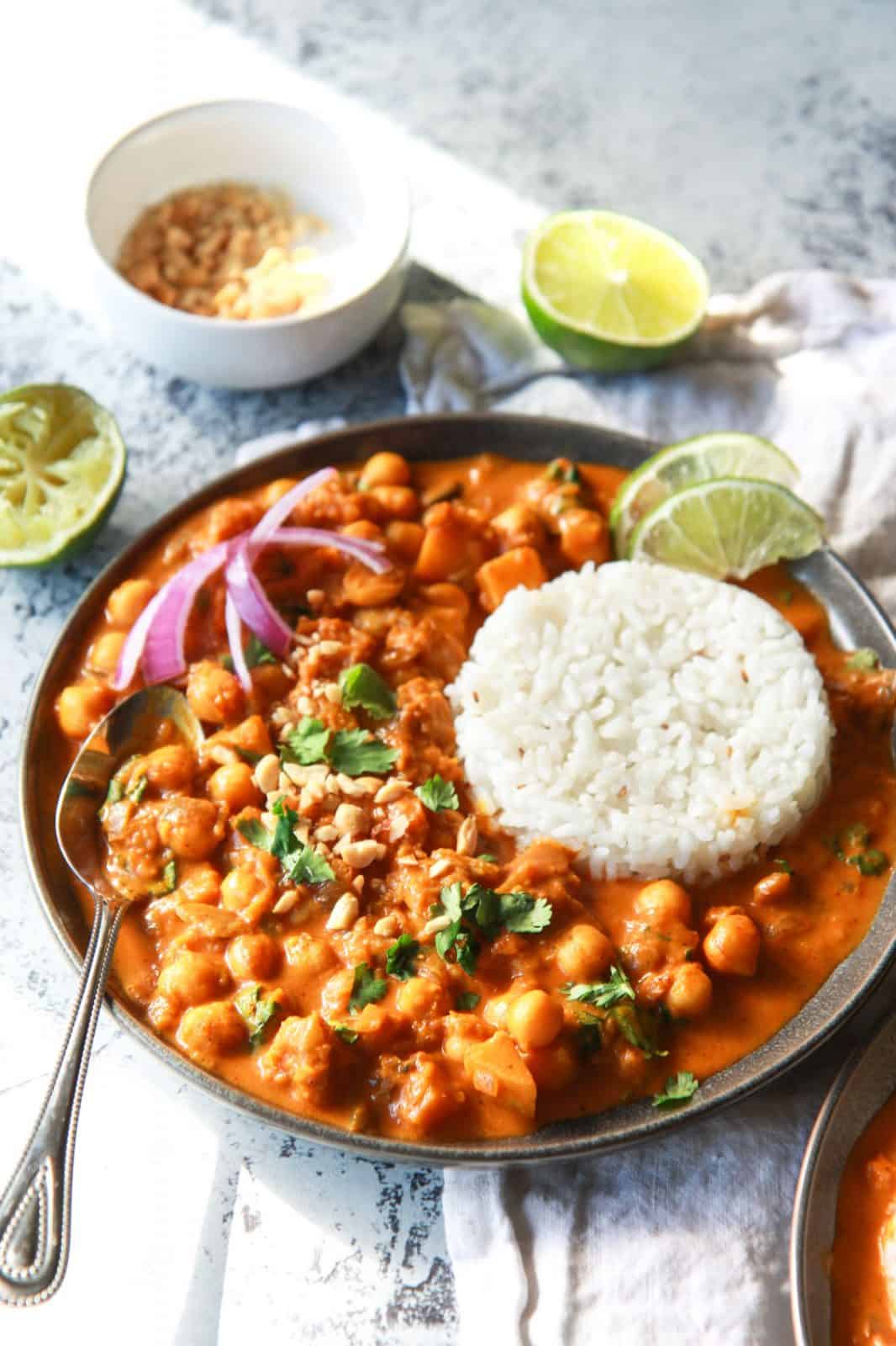 This vegan butternut squash & chickpea panang curry is a sweet, peanut flavored curry, inspired by the classic Thai dish. This vegan Thai peanut curry uses vegan panang curry paste, peanut butter, and coconut milk to create a rich and creamy base. This plant based curry uses chickpea and butternut squash instead of meat. Gluten-free with an oil-free option.