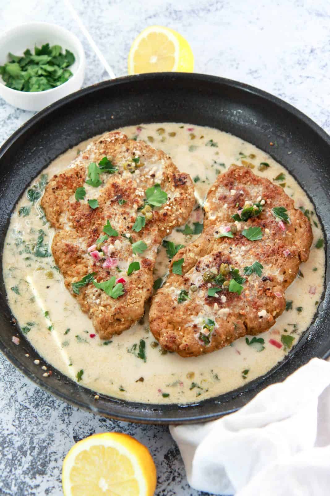 This vegan chicken piccata recipe is so close to the real thing! Homemade seitan is a protein packed, plant based meat alternative that works great in this dish. In this seitan piccata, the vegan chicken is breaded and served over pasta in a light, creamy, lemon caper sauce.