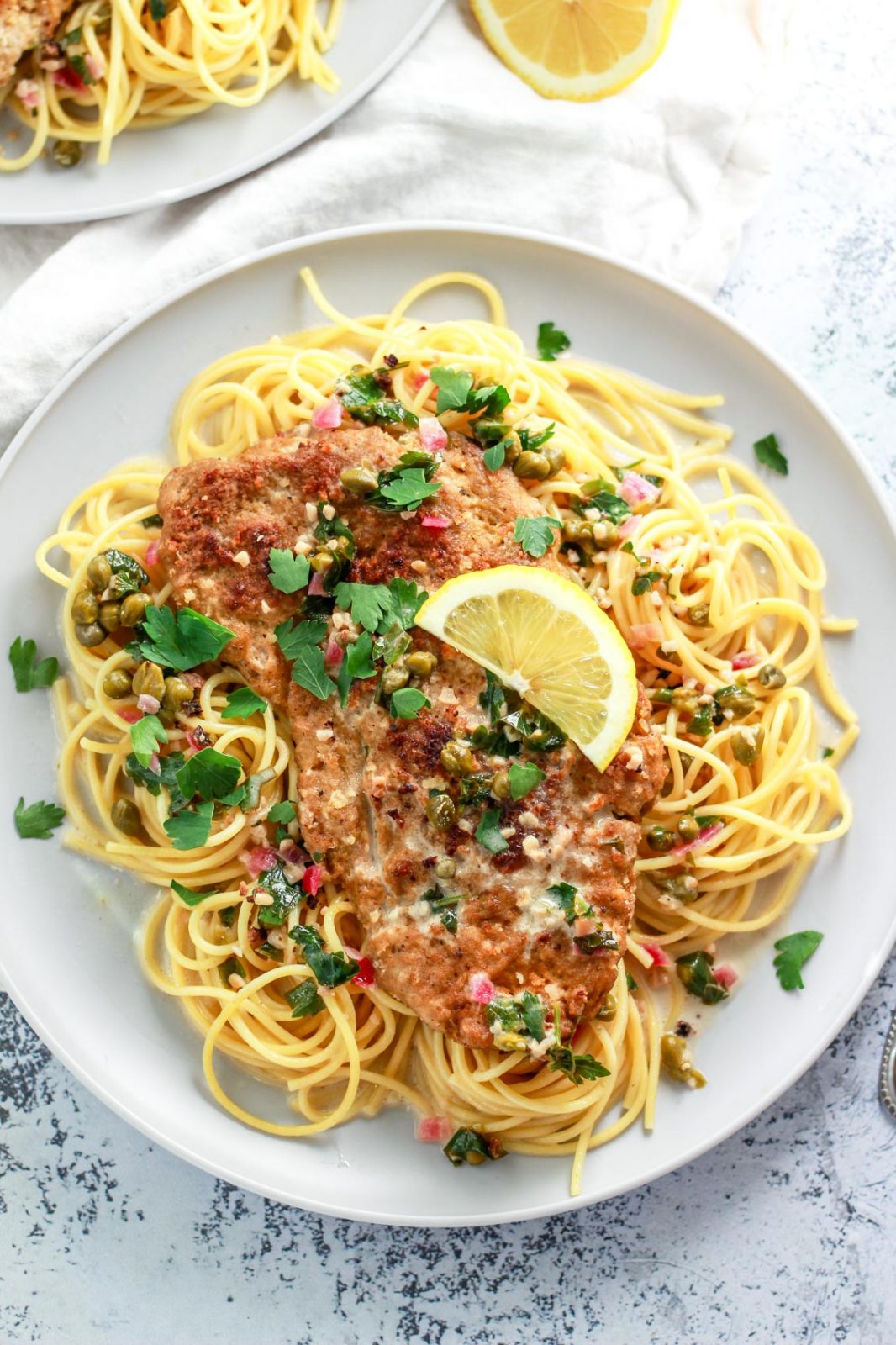 This vegan chicken piccata recipe is so close to the real thing! Homemade seitan is a protein packed, plant based meat alternative that works great in this dish. In this seitan piccata, the vegan chicken is breaded and served over pasta in a light, creamy, lemon caper sauce.