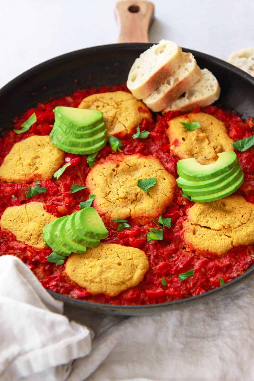 This vegan shakshuka make a delicious Middle Eastern breakfast. This Mediterranean brunch recipe is made plant based using chickpea based eggs baked in a tomato and red pepper sauce.