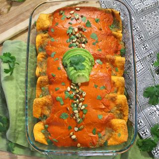 The best sweet potato and black bean enchiladas covered in tangy salsa verde and a gooey, vegan chipotle cashew cheese.