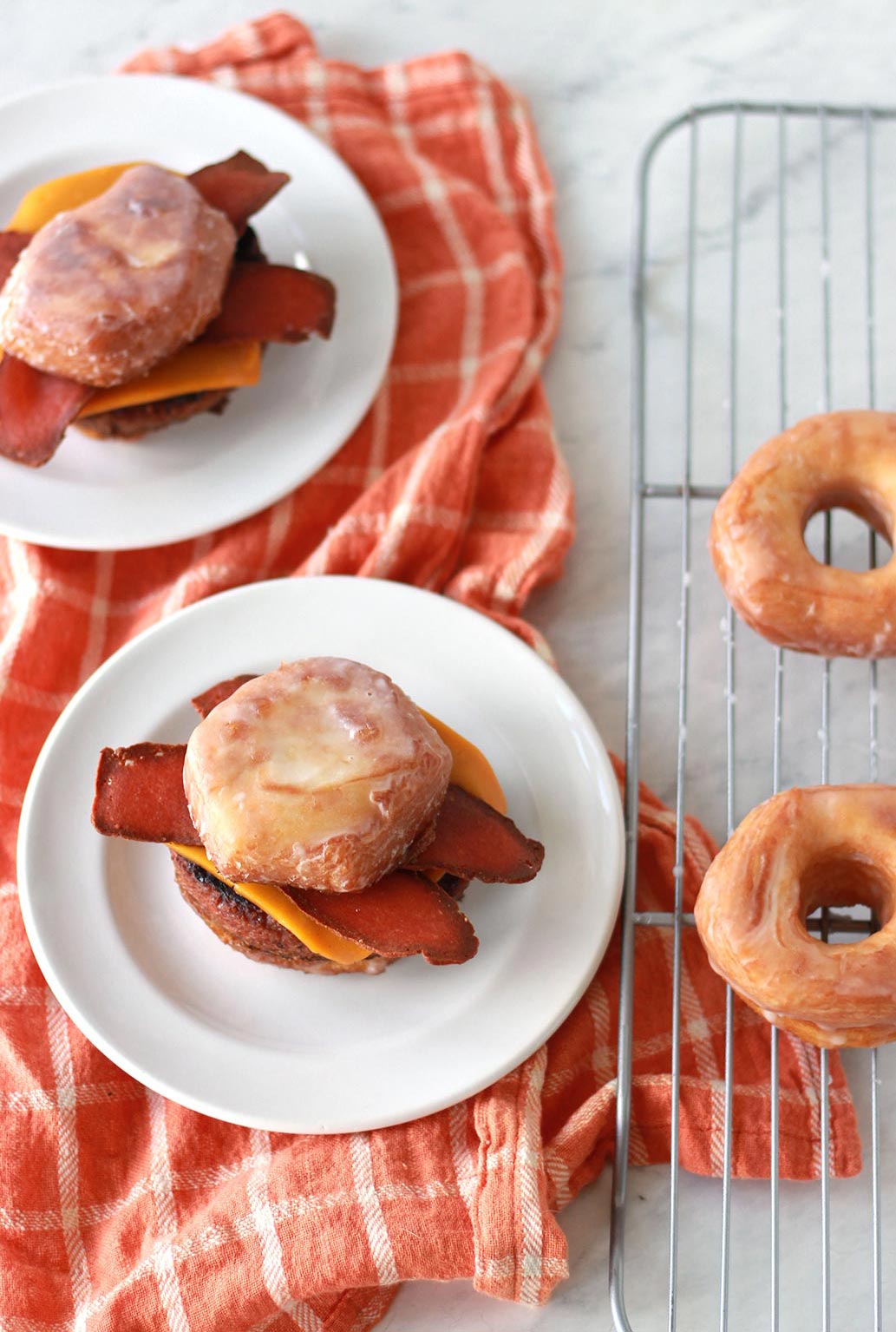 This vegan bacon cheeseburger is sandwiched between two glazed donuts as buns! Also known as the Luther Burger, this innovative plant based burger recipe comes with an easy vegan donut hack.