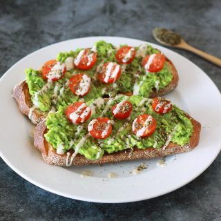 This zaatar avocado toast is a Mediterranean twist on your classic avocado toast, dressed with juicy cherry tomatoes and a creamy 3-ingredient tahini drizzle. This vegan recipe is a modern twist on the classic Middle Eastern breakfast staple of bread with zaatar and olive oil.