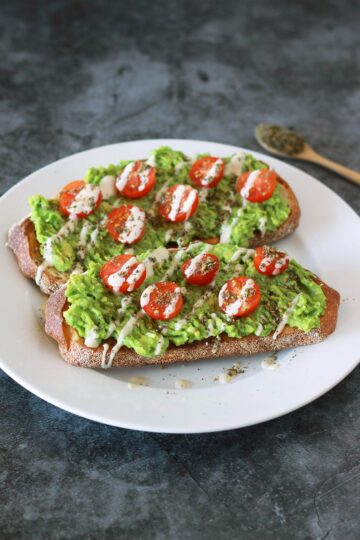 This zaatar avocado toast is a Mediterranean twist on your classic avocado toast, dressed with juicy cherry tomatoes and a creamy 3-ingredient tahini drizzle. This vegan recipe is a modern twist on the classic Middle Eastern breakfast staple of bread with zaatar and olive oil.