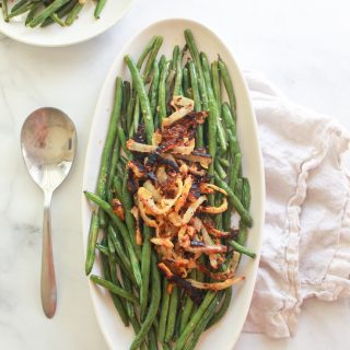 These oven roasted lemon garlic green beans topped with chickpea fried onions make a delicious vegan Thanksgiving side dish.