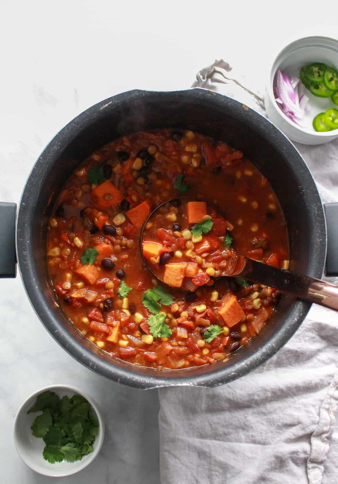 This warming lentil and sweet potato chili is the perfect comfort food for colder months. Packed full of flavor, this vegan sweet potato chili recipe is also gluten-free.