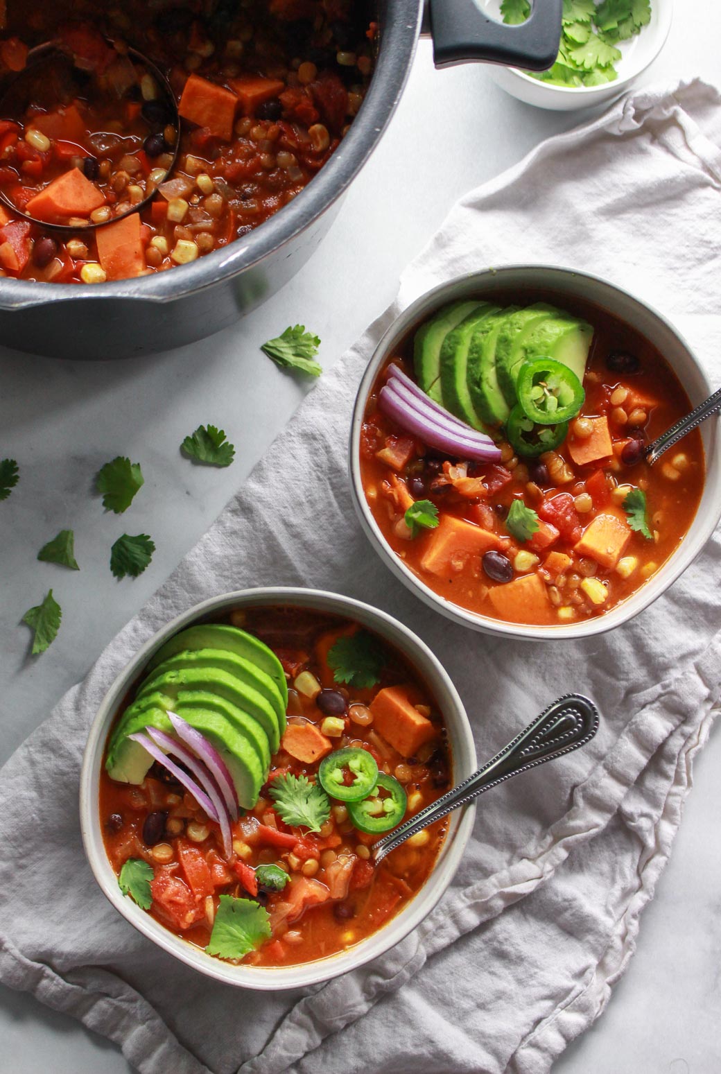 This warming lentil and sweet potato chili is the perfect comfort food for colder months. Packed full of flavor, this vegan sweet potato chili recipe is also gluten-free.