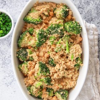 This cheesy vegan quinoa with broccoli and chickpeas is a healthy comfort food dish that can be made in one pot. This savory gluten free recipe is made creamy with cashews and seasoned with garlic.