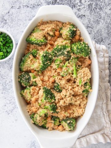 This cheesy vegan quinoa with broccoli and chickpeas is a healthy comfort food dish that can be made in one pot. This savory gluten free recipe is made creamy with cashews and seasoned with garlic.