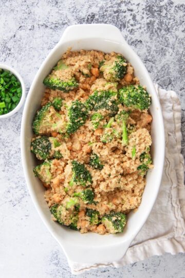 This cheesy vegan quinoa with broccoli and chickpeas is a healthy comfort food dish that can be made in one pot. This savory gluten free recipe is made creamy with cashews and seasoned with garlic.