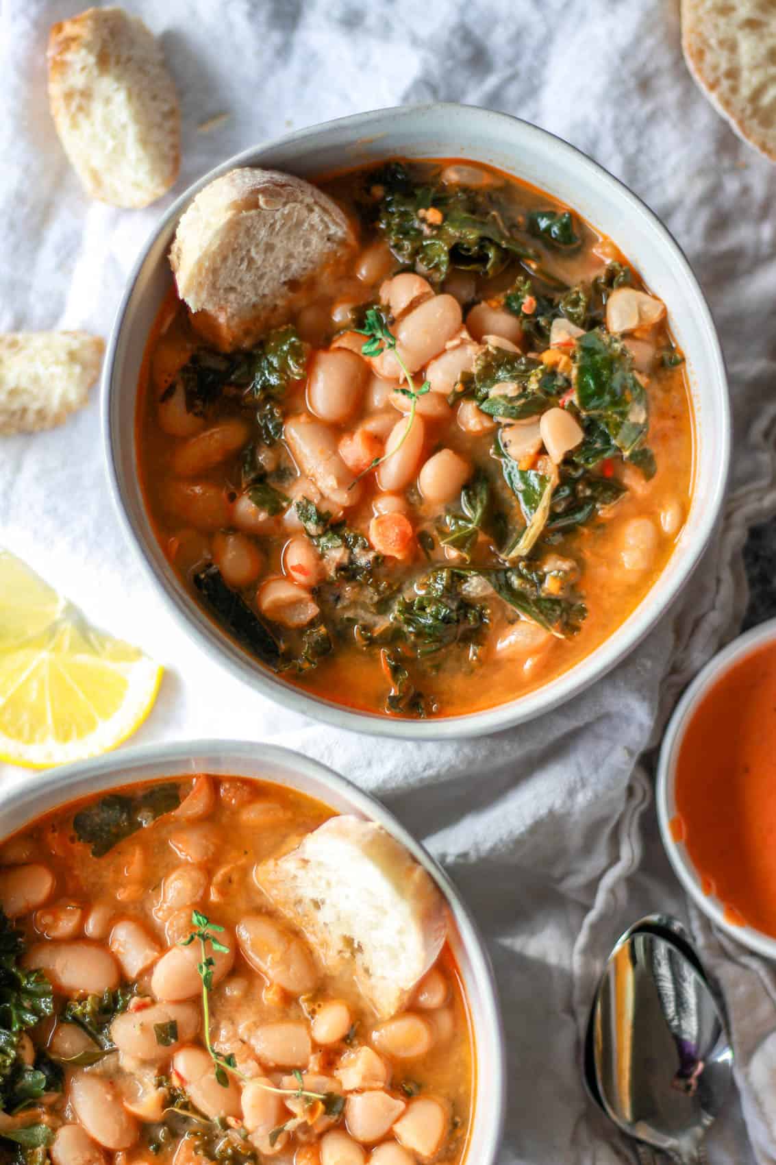 This Mediterranean white bean soup is flavored with Harissa and tahini. Filled with kale, parsley, and thyme, this vegan white bean soup is hearty, flavorful, and creamy.