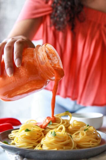 This roasted red pepper tahini sauce is a vegan recipe that is super creamy, oil-free, and perfect over pasta. It is made of sesame paste and roasted red bell peppers.