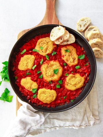 This vegan shakshuka make a delicious Middle Eastern breakfast. This Mediterranean brunch recipe is made plant based using chickpea based eggs baked in a tomato and red pepper sauce.