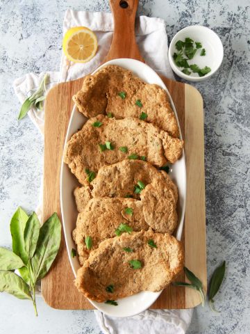 These seitan chicken cutlets are easy and versatile. A vegan meat replacement, these seitan chicken breasts are simmered and done in under an hour. This plant based chicken alternative recipe is made from vital wheat gluten, packed with protein, and flavored with savory herbs.