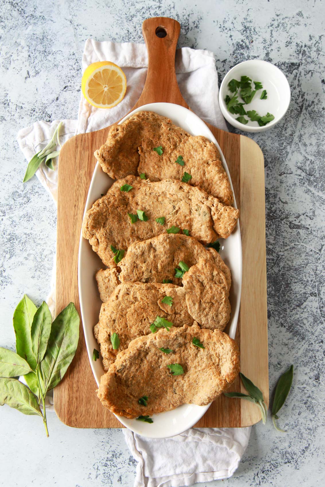 These seitan chicken cutlets are easy and versatile. A vegan meat replacement, these seitan chicken breasts are simmered and done in under an hour. This plant based chicken alternative recipe is made from vital wheat gluten, packed with protein, and flavored with savory herbs.