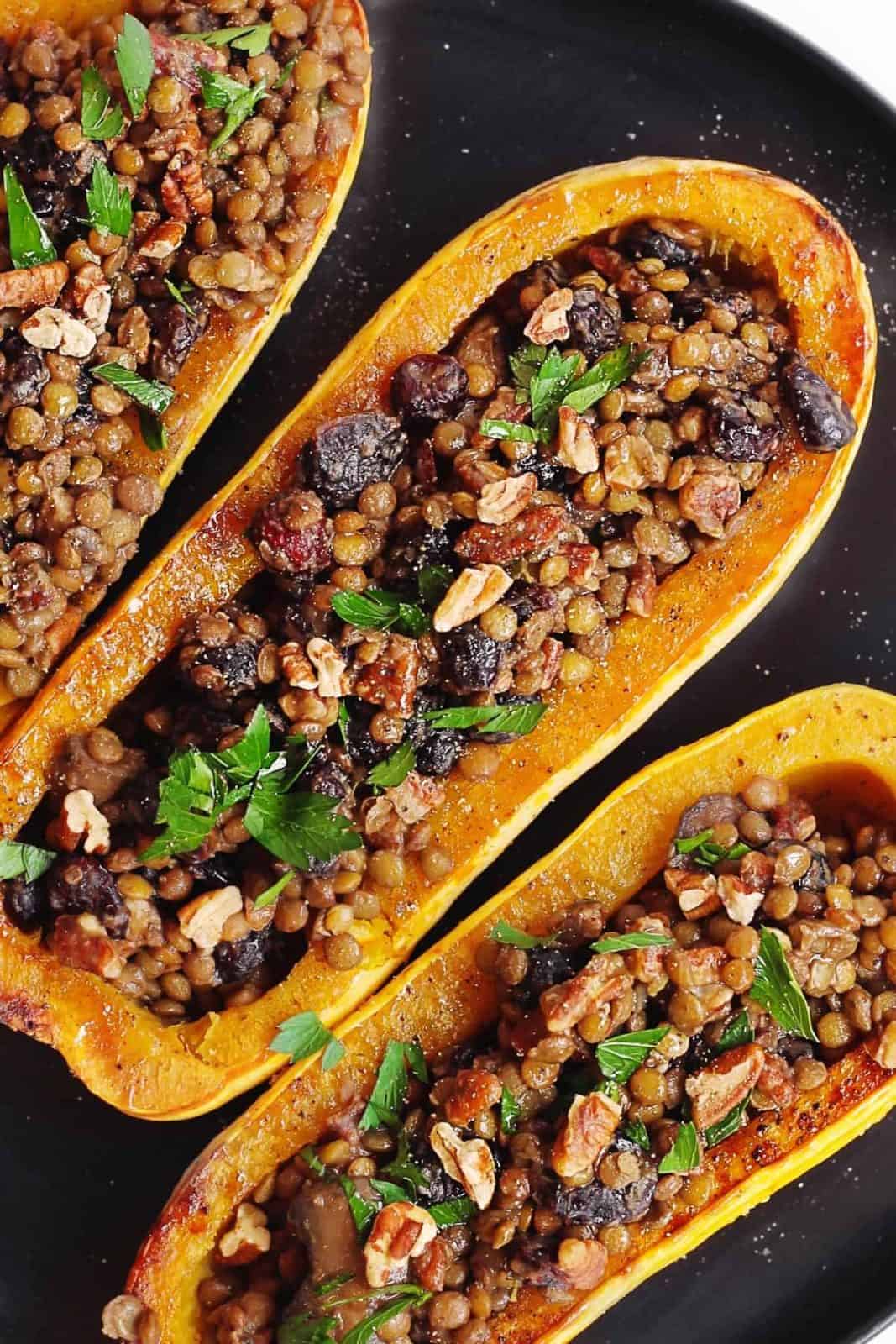 These lentil stuffed delicata squash are a filling vegan Thanksgiving main.