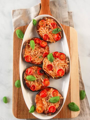 These vegan portobello pizzas are a healthy, dairy free way to enjoy the flavors of pizza. Also gluten-free, you can customize each portobello pizza in this recipe to your liking with vegan cheese and veggie toppings.