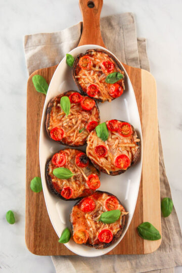 These vegan portobello pizzas are a healthy, dairy free way to enjoy the flavors of pizza. Also gluten-free, you can customize each portobello pizza in this recipe to your liking with vegan cheese and veggie toppings.