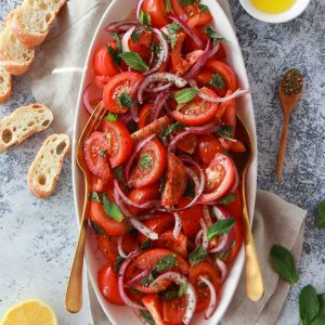 a photo showing the mediterranean tomato salad with zaatar, lemon, and olive oil