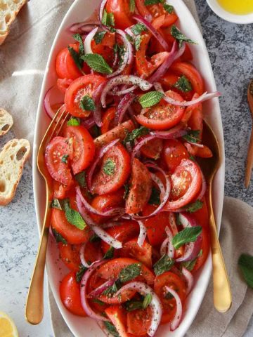 a photo showing the mediterranean tomato salad with zaatar, lemon, and olive oil