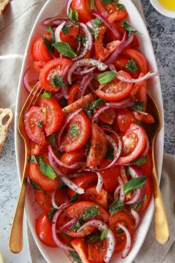 a photo showing the mediterranean tomato salad with zaatar, lemon, and olive oil