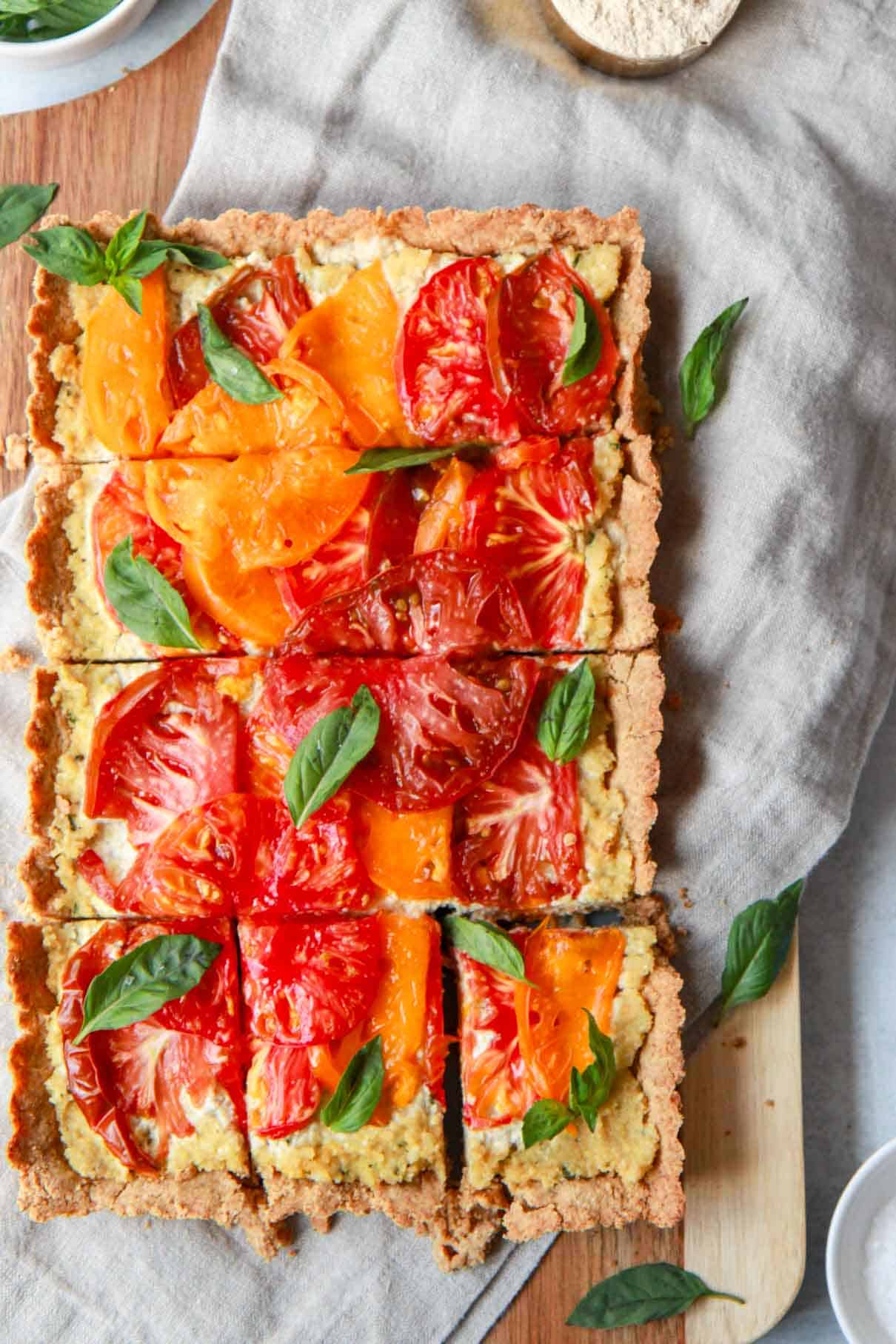 This image shows the vegan heirloom tomato tart sliced into squares