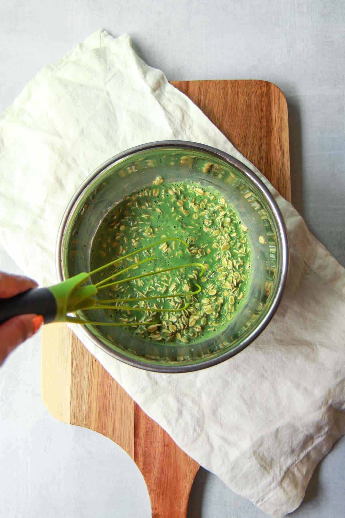 Whisking the overnight oats and chia seeds with matcha milk