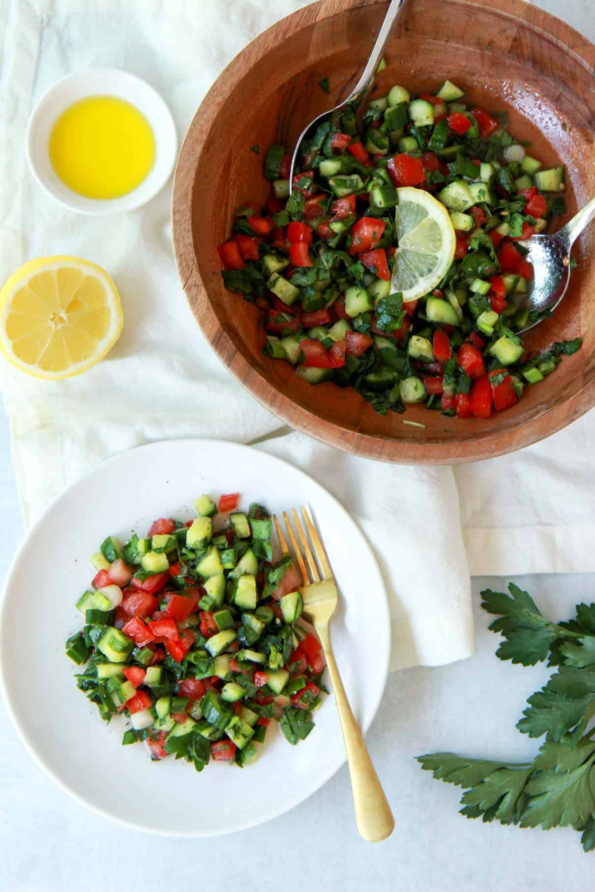 This photo depicts the salad served on a small plate with the rest of the salad in a large mixing bowl in the background.