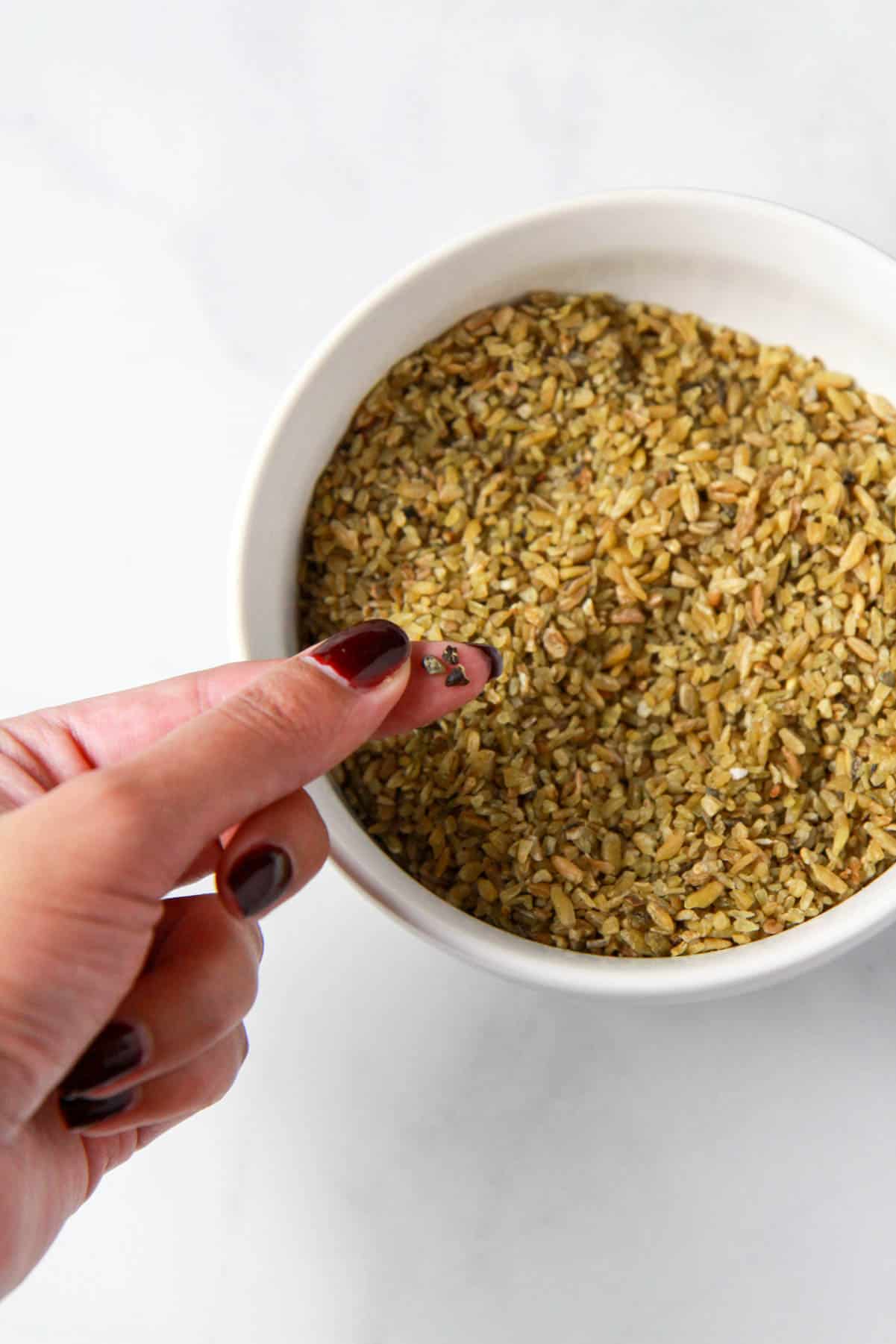 This image shows sifting through the freekeh to remove any small pebbles.