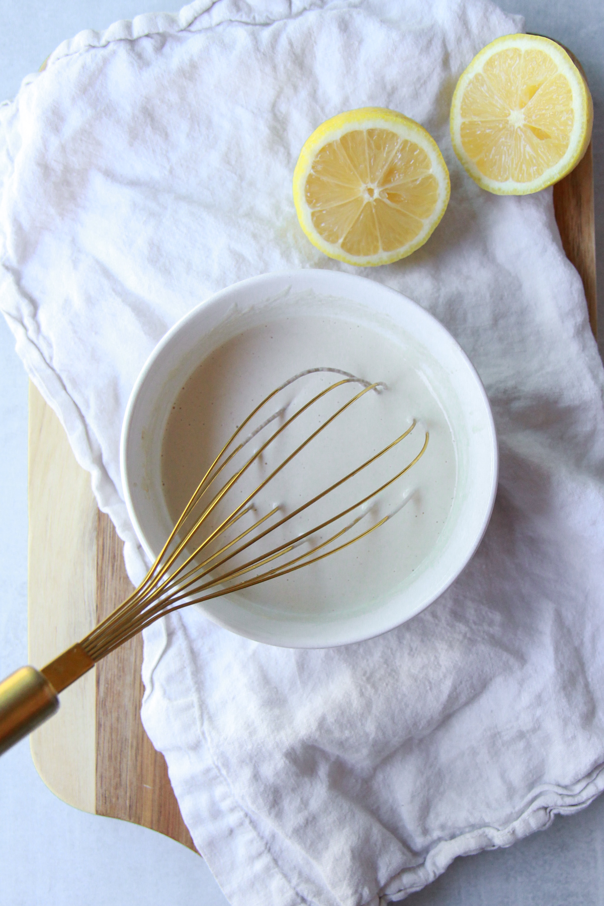 Thinning the tahini sauce with water.