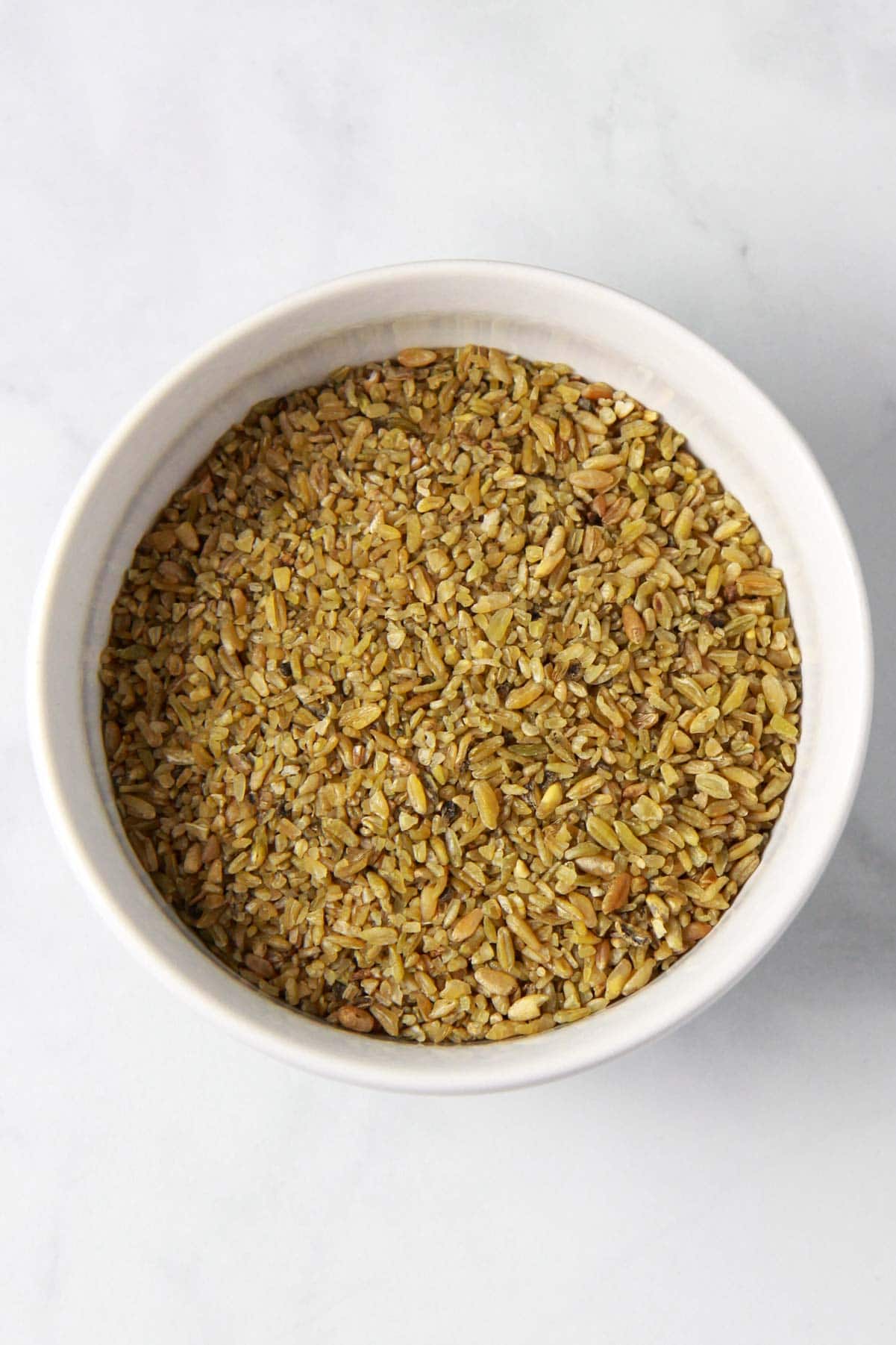 This image shows the freekeh grain, green cracked wheat, up close.