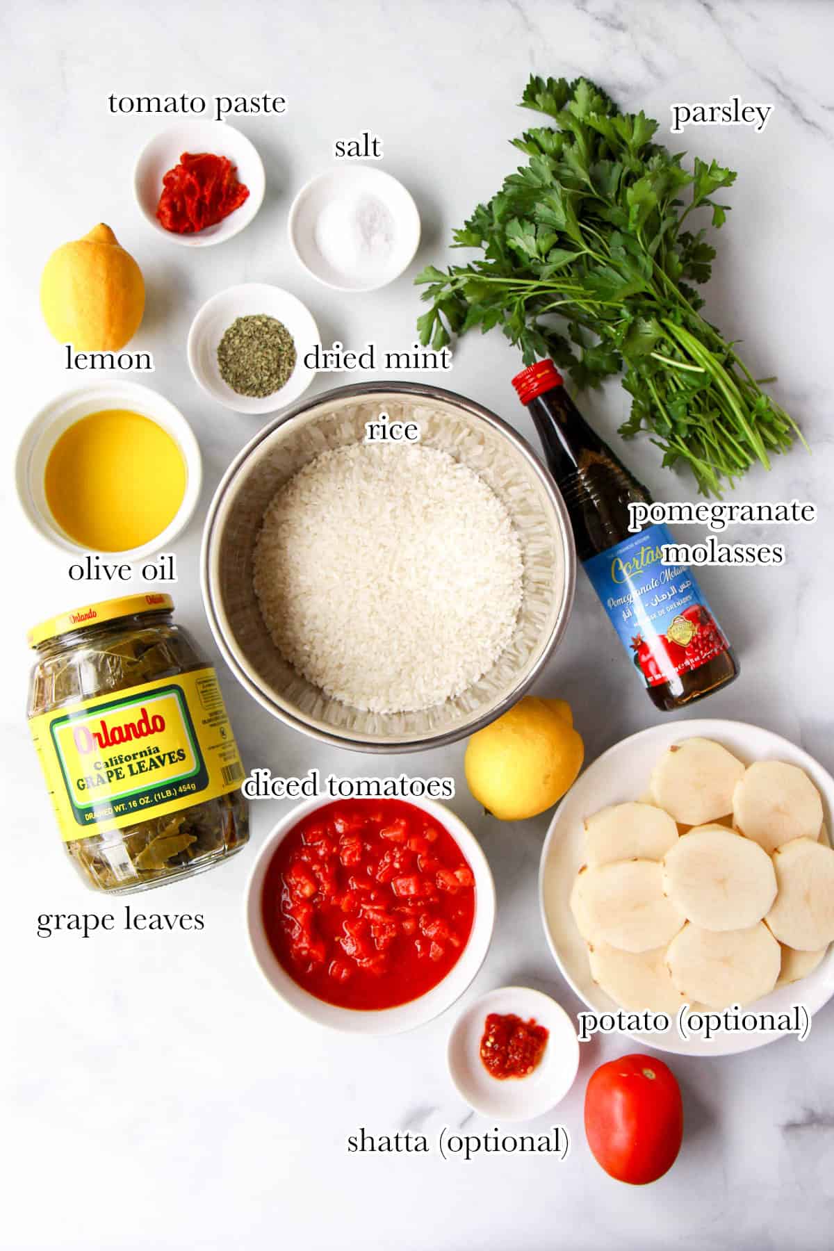 Yalanji dolma ingredients including grape leaves, rice, tomatoes, lemon, olive oil, herbs, and more.