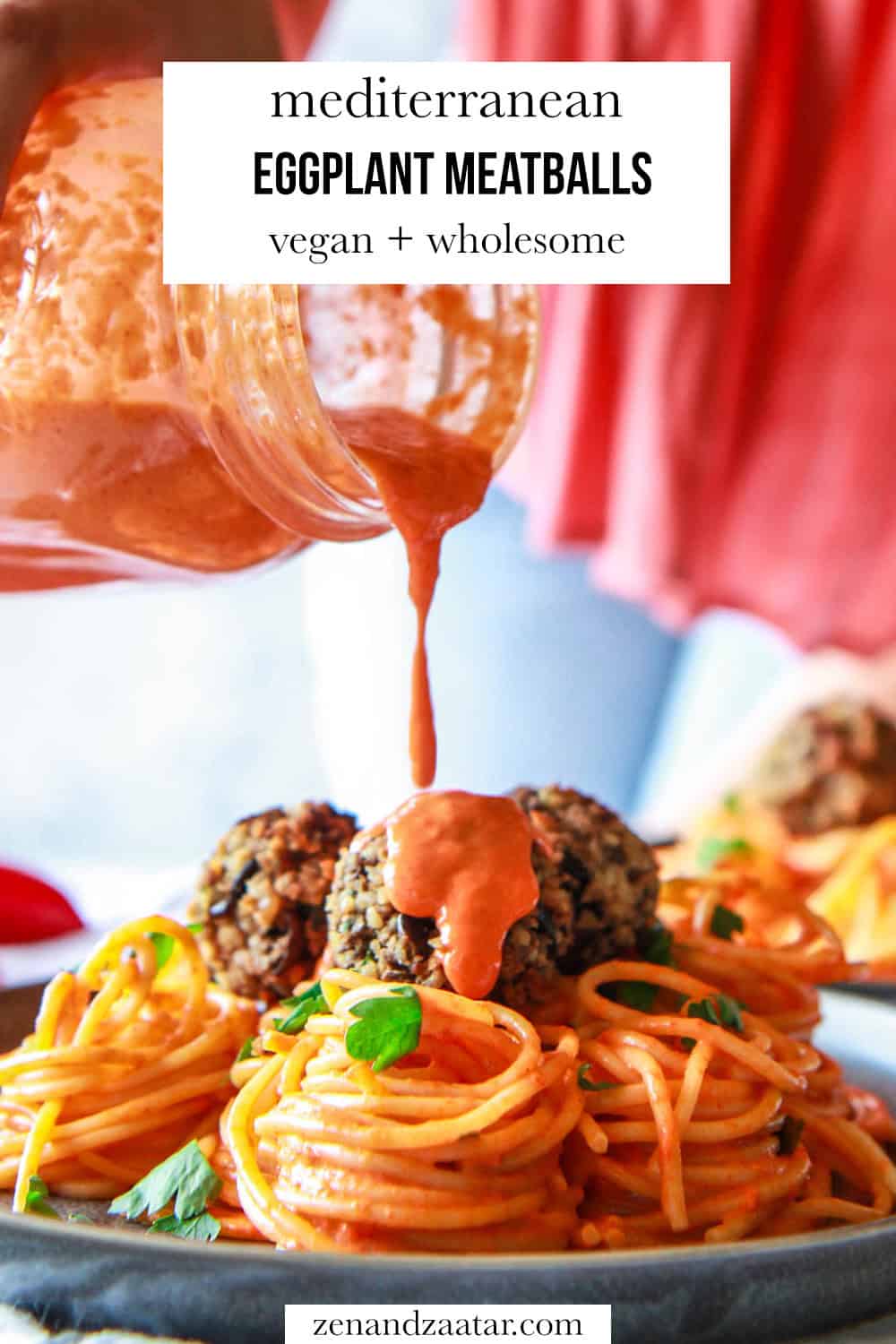 Eggplant meatballs with red pepper sauce being poured over them, with text overlay, "Mediterranean eggplant meatballs - vegan + wholesome."