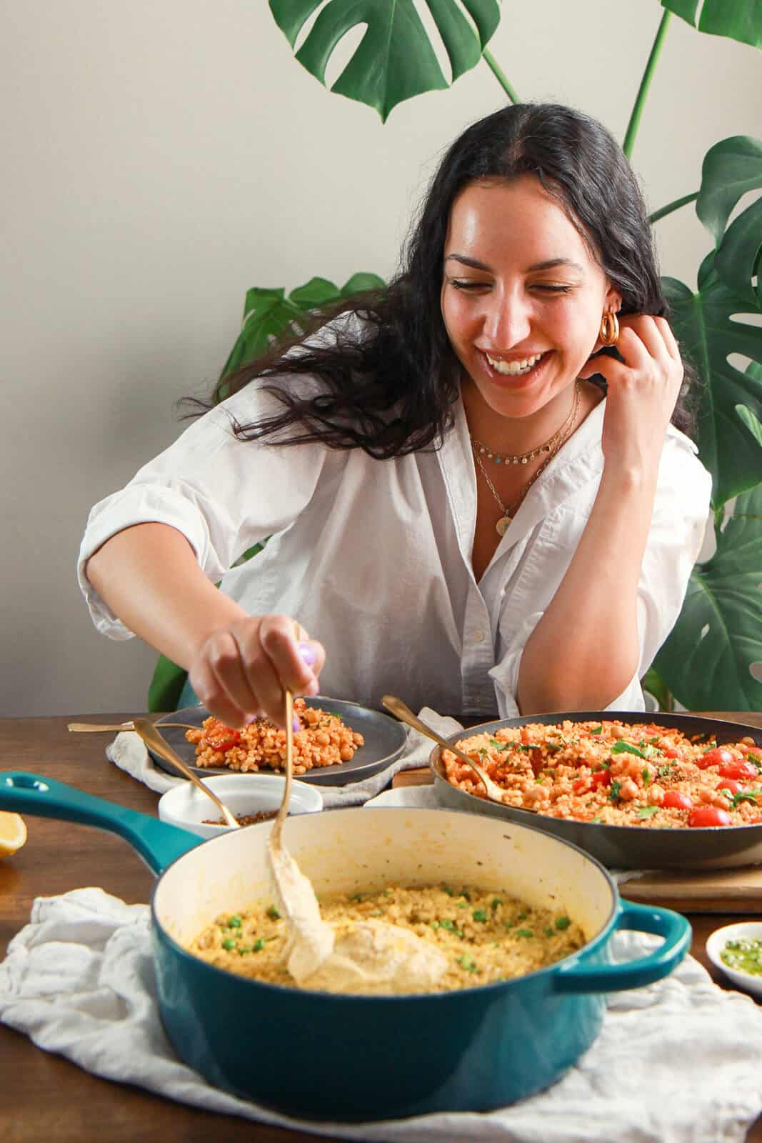 Zena Hassoun, M.S., laughing while serving her vegan creations.