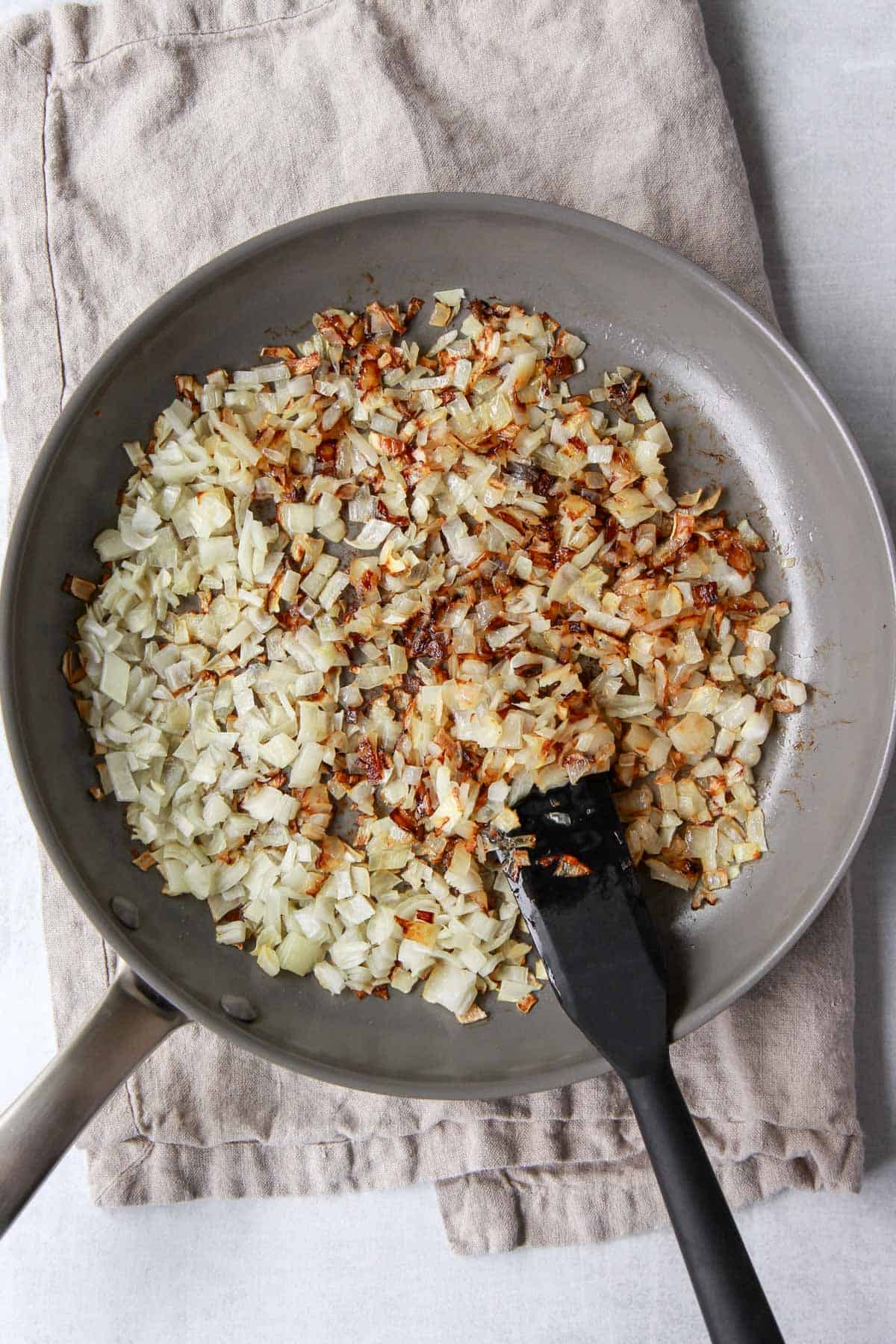Crisping the onions in olive oil in a pan.