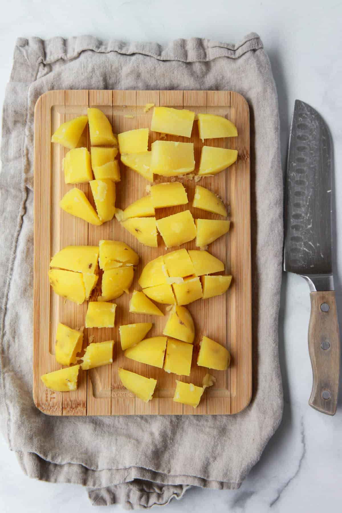 Chopping the boiled potatoes.