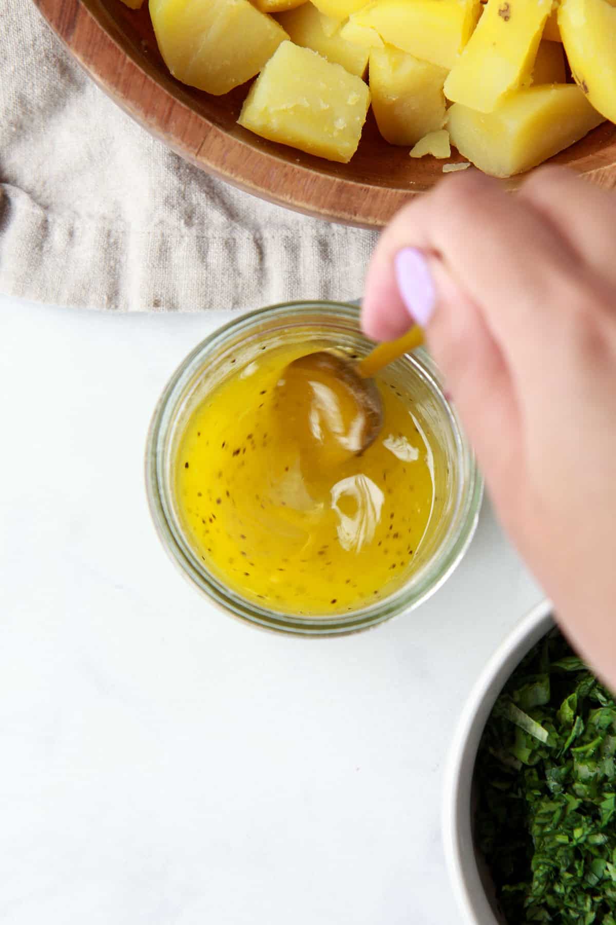 Mixing potato salad dressing.