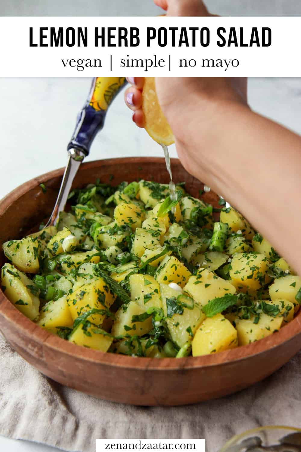 Squeezing lemon over potato salad with text overlay, "Lemon herb potato salad: vegan, simple, no mayo".