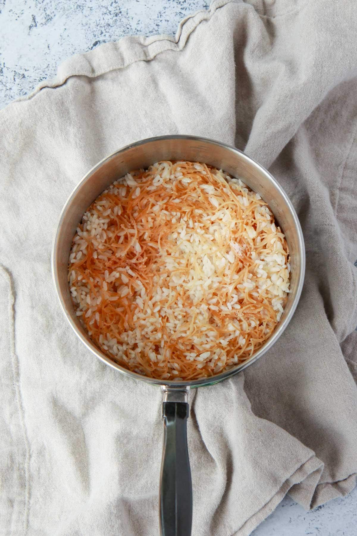 Cooked vermicelli rice before steaming and fluffing.
