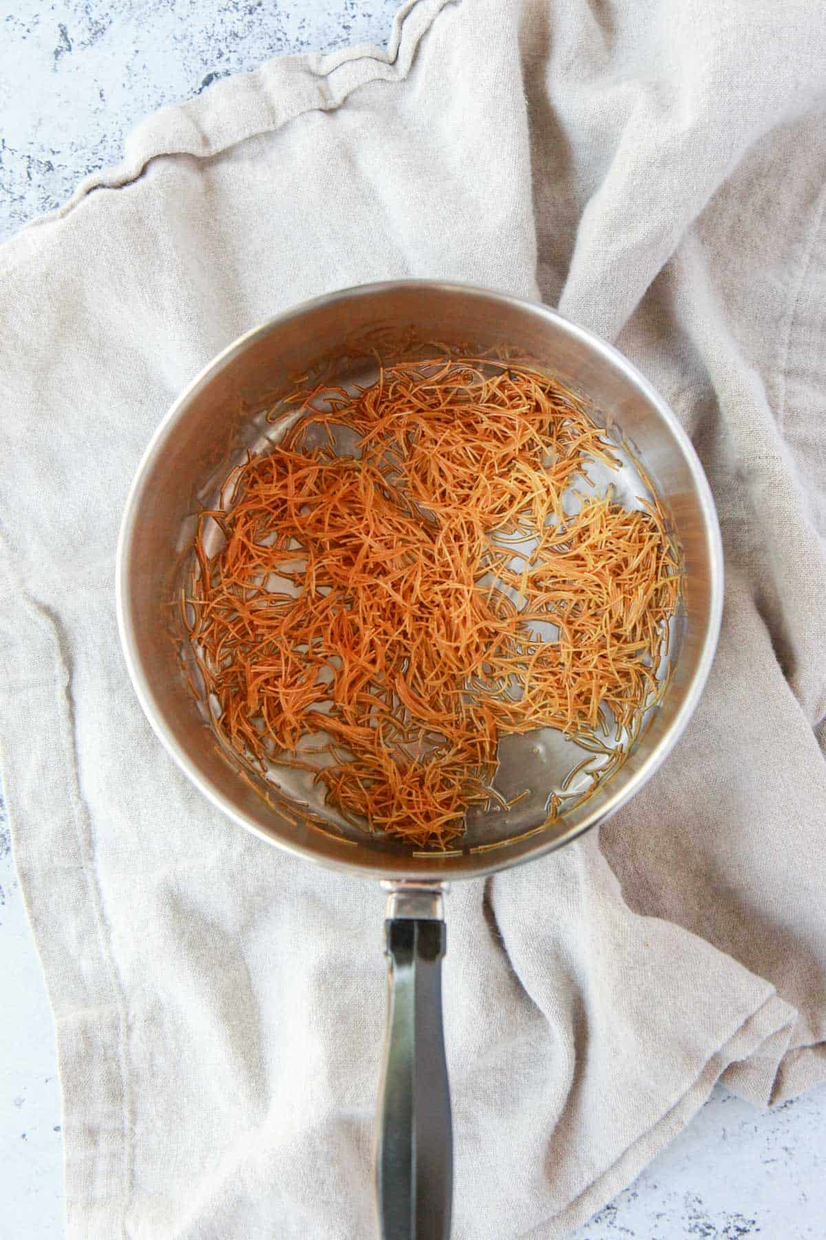 Golden vermicelli noodles after toasting.