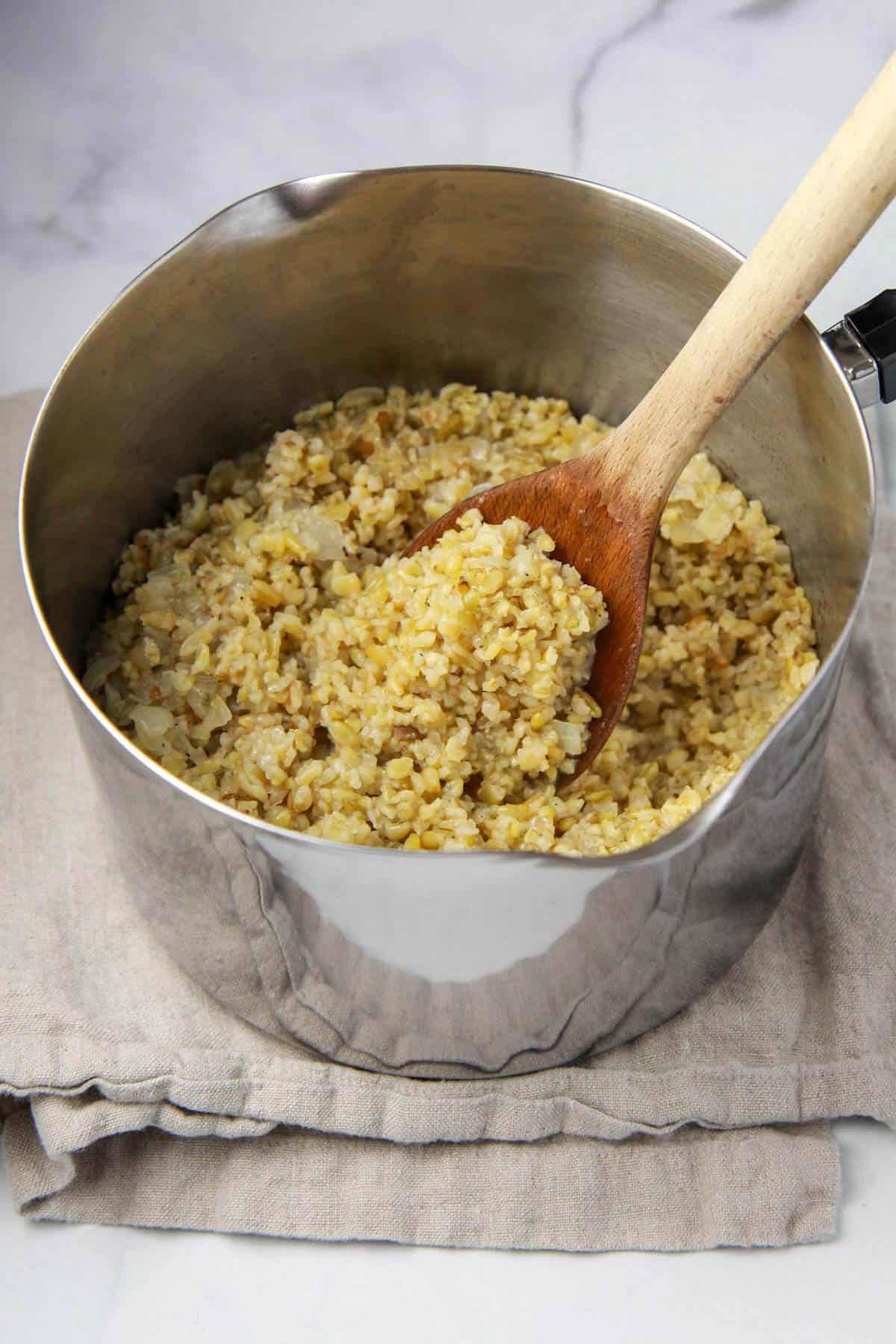 Cooked freekeh in a pot, an ancient grain.