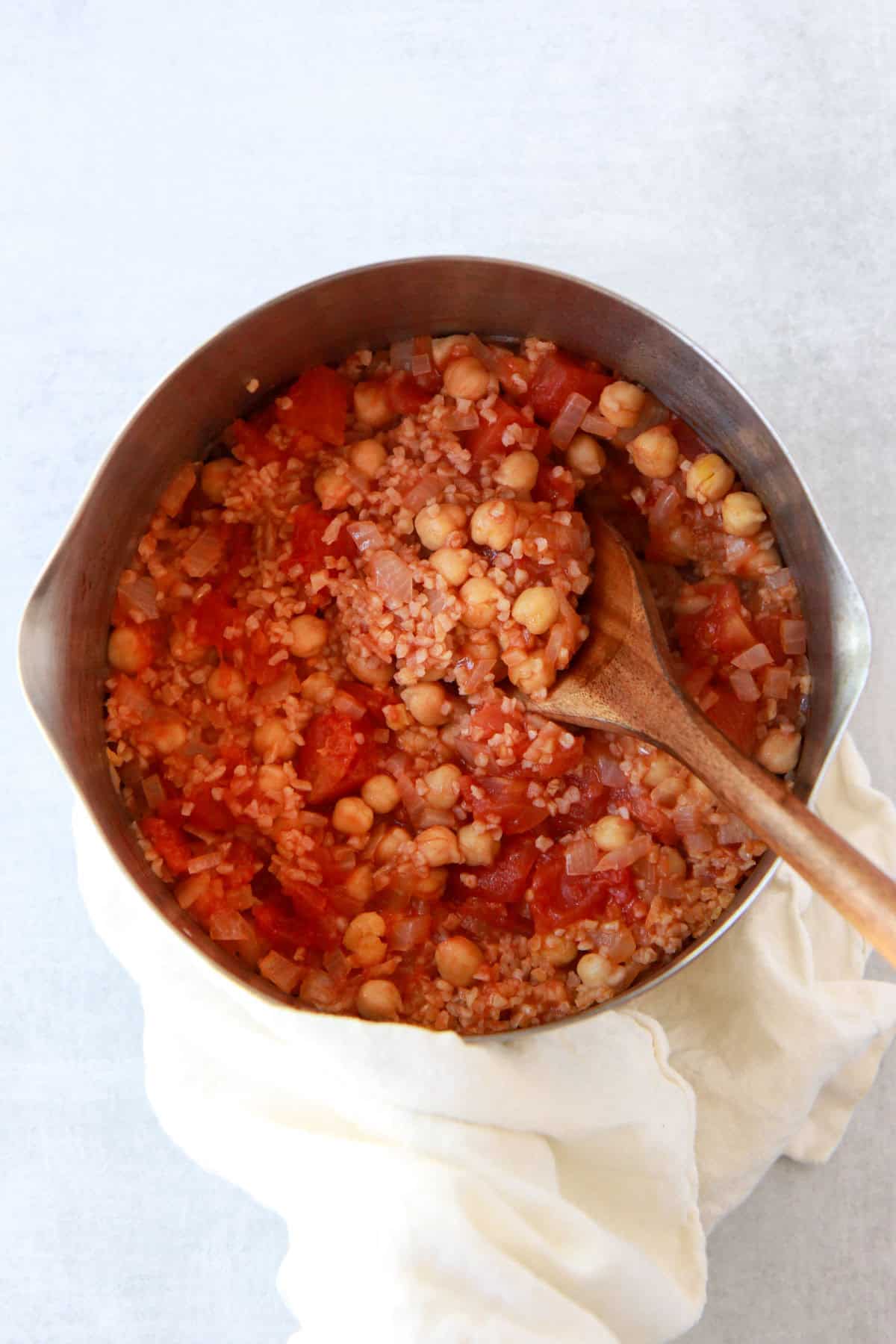 This image shows the bulgur pilaf fluffy and soaking up tomato juices before adding squash.