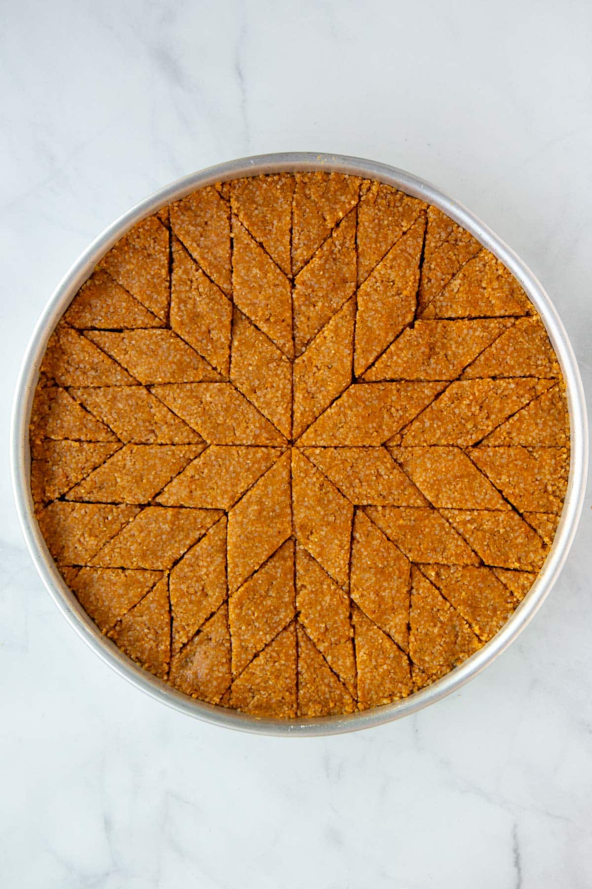 Unbaked kibbeh cut into diamond shapes, making the kibbeh star.
