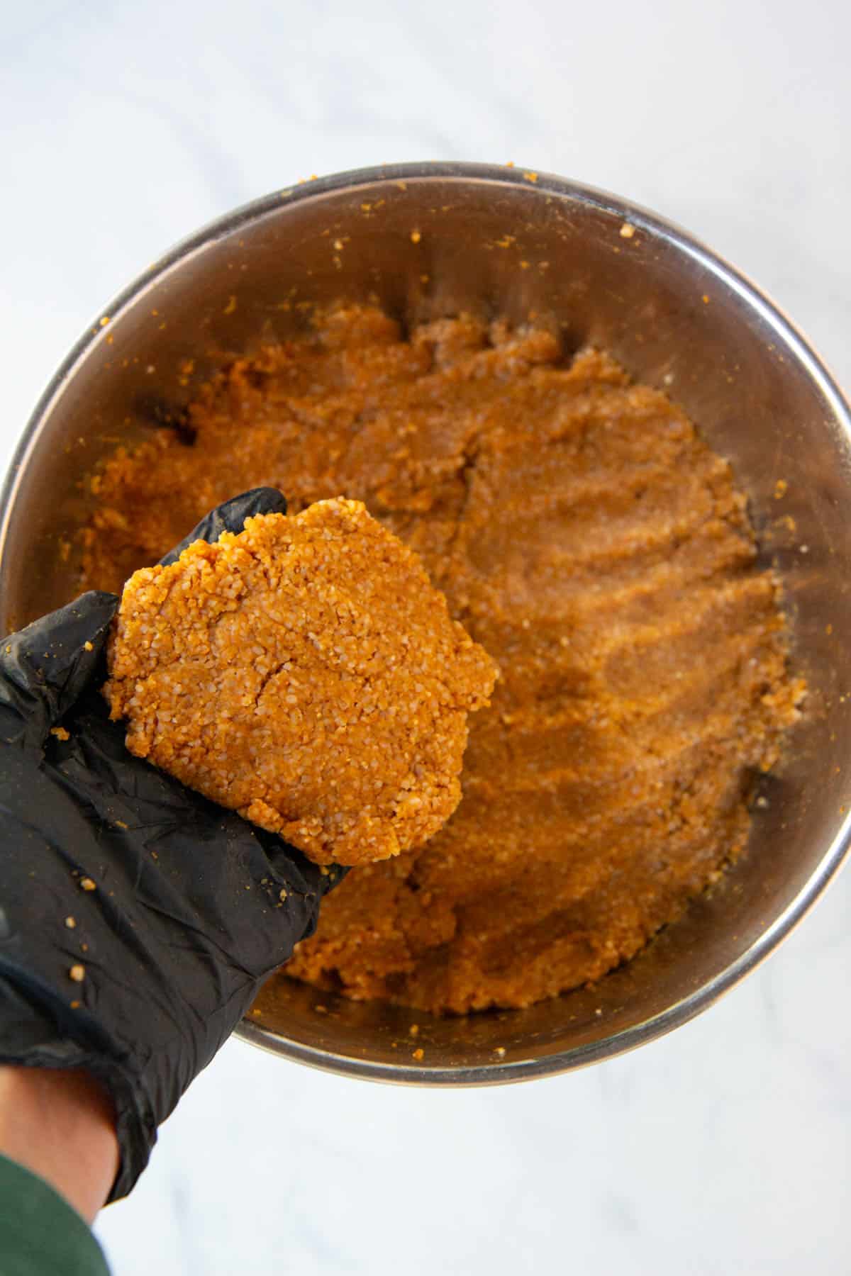 Showing the texture of the pumpkin-bulgur dough.