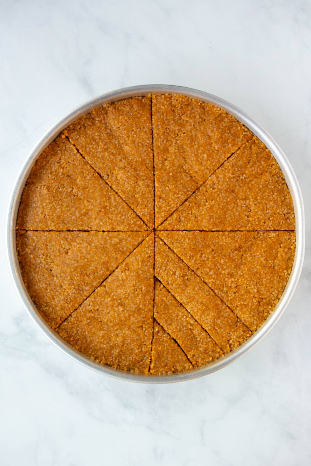 Unbaked kibbeh with 1 wedge cut into 3 equal portions.