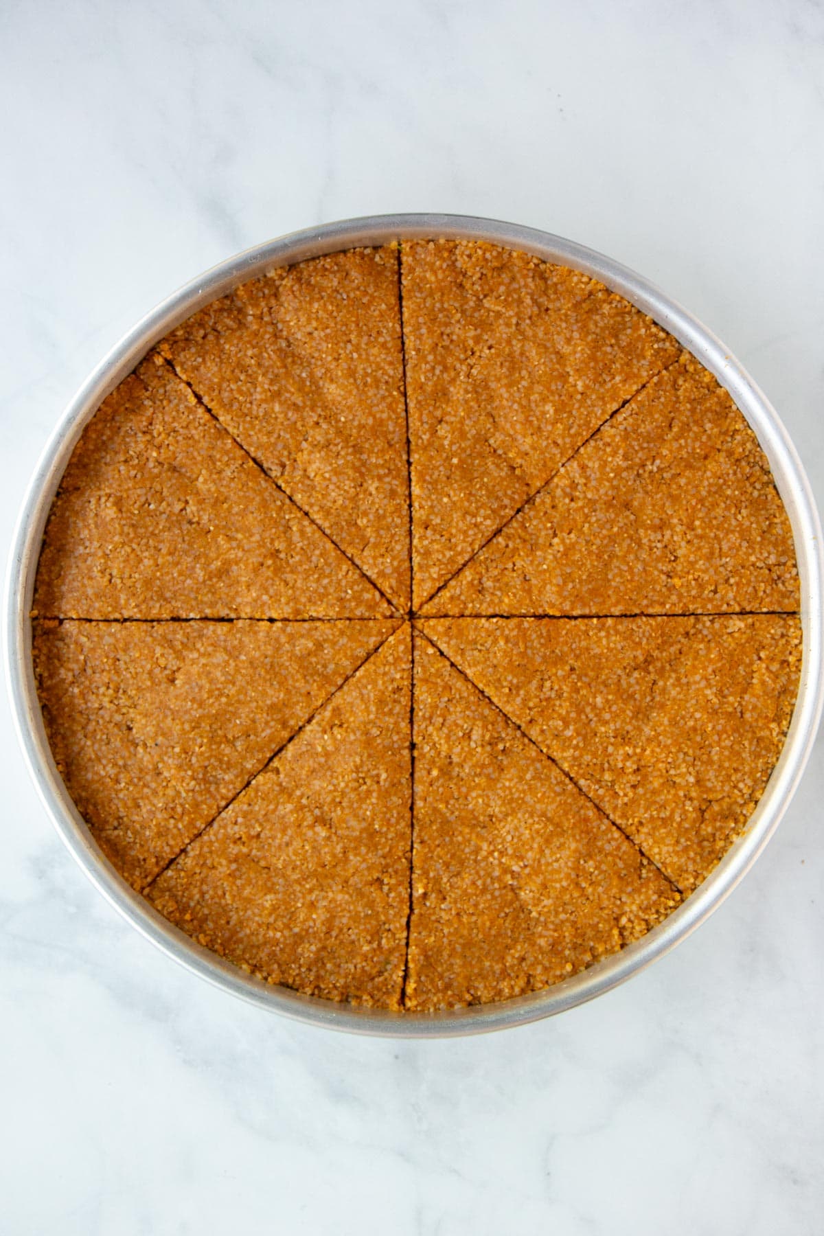 Unbaked kibbeh cut into 8 equal wedges.