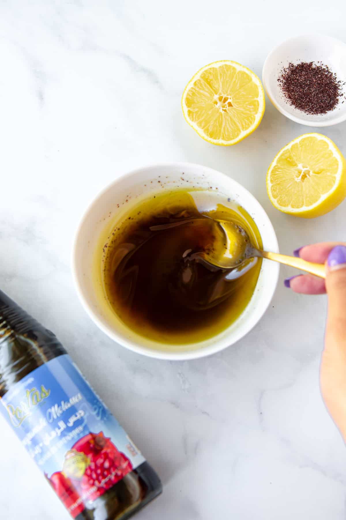 Mixing ingredients for fattoush salad dressing.